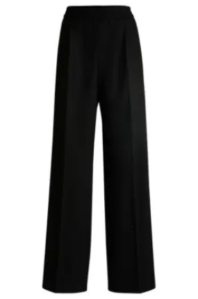 Pantalones de traje relaxed fit de género neutro con raya diplomática